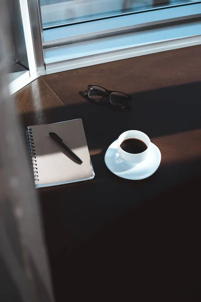Taza de café y cuaderno - foto de stock