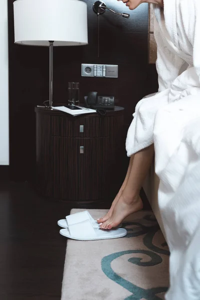 Woman waking up in hotel room — Stock Photo