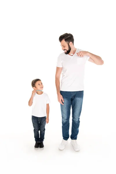 Family holding toothbrushes — Stock Photo