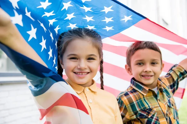 Siblings with american flag — Stock Photo