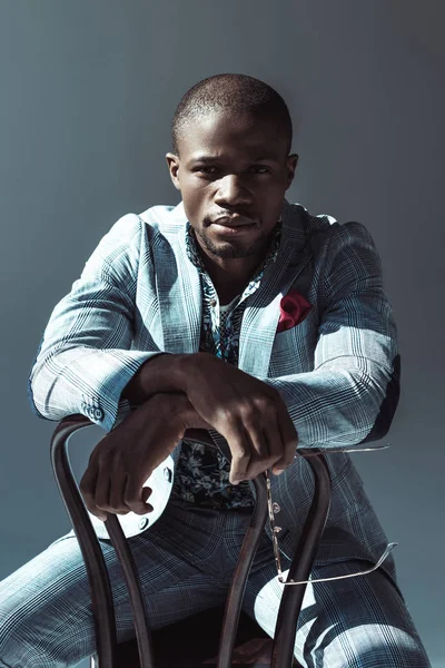 Stylish man sitting on chair backwards — Stock Photo