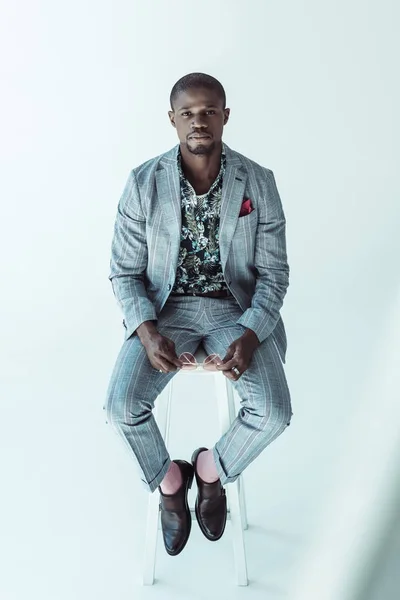 African american man in suit on bar stool — Stock Photo