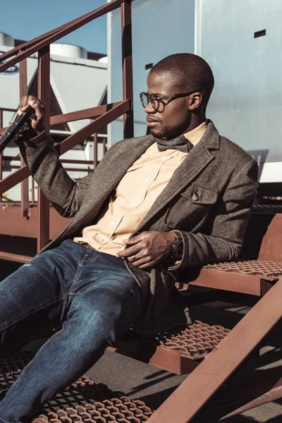 Stylish man posing on stairs — Stock Photo