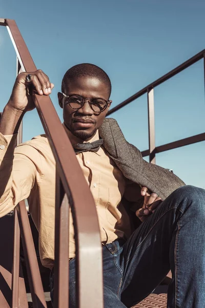 African american man sitting on stairs — Stock Photo