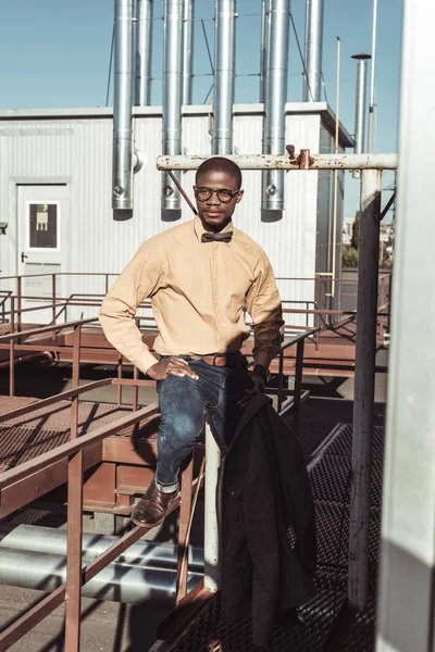 African american man sitting on guardrails — Stock Photo