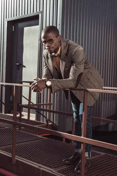 Handsome african american man leaning on guardrails — Stock Photo