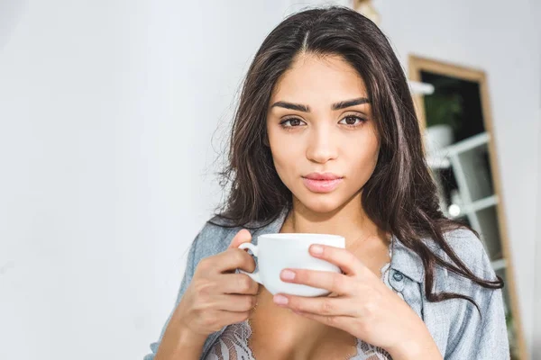 Girl in lingerie drinking coffee — Stock Photo