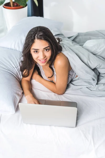 Young woman with laptop at home — Stock Photo