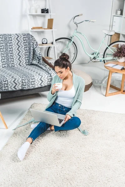 Young woman with laptop at home — Stock Photo