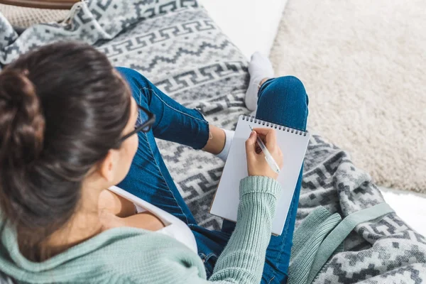 Girl with notebook at home — Stock Photo