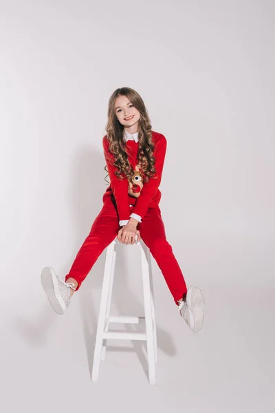 Girl in red sweater with reindeer — Stock Photo