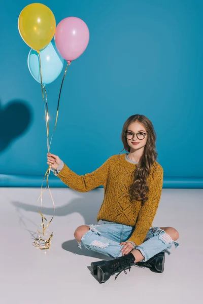 Stylish teenage girl with balloons — Stock Photo