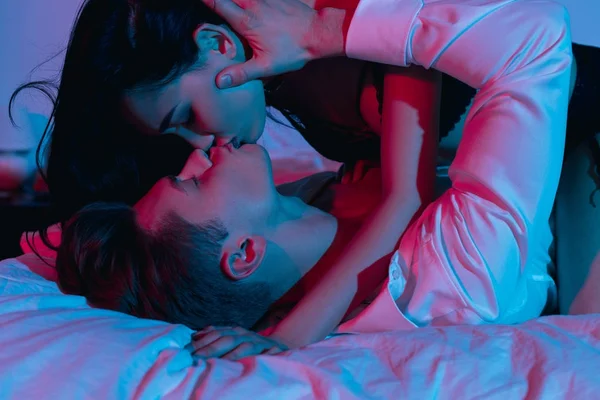 Couple kissing in bed — Stock Photo