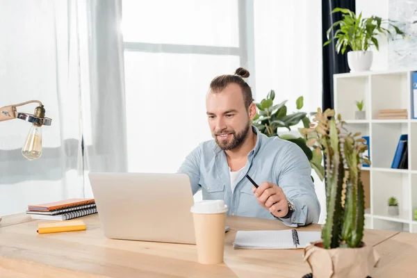 Young man working with laptop — Stock Photo