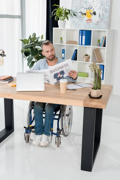 Disabled man reading newspaper — Stock Photo