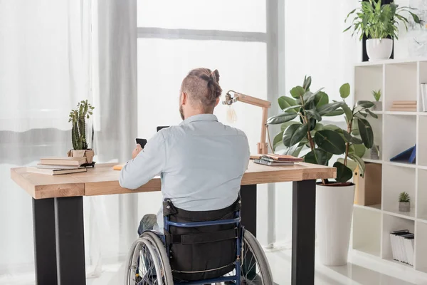 Disabled man using smartphone — Stock Photo