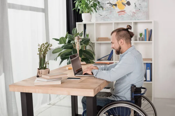 Disabled man using laptop — Stock Photo