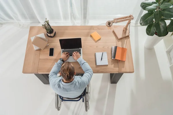 Disabled man using laptop — Stock Photo