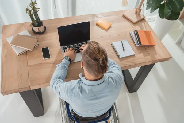 Disabled man using laptop — Stock Photo