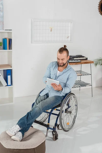 Hombre en silla de ruedas usando tableta — Stock Photo