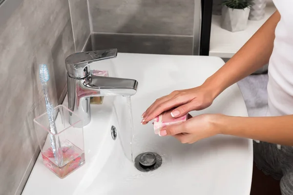 Girl washing hands with soap — Stock Photo