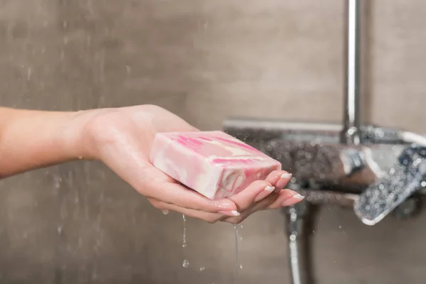 Girl holding soap in hand — Stock Photo