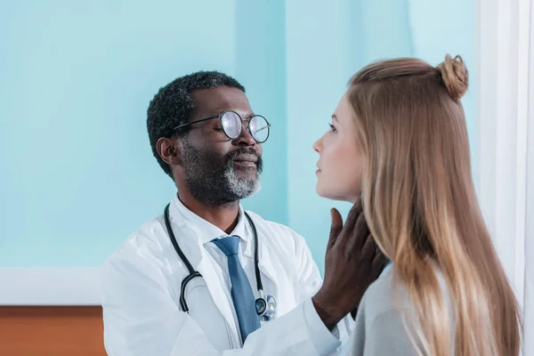 Doctor palpating lymph nodes — Stock Photo