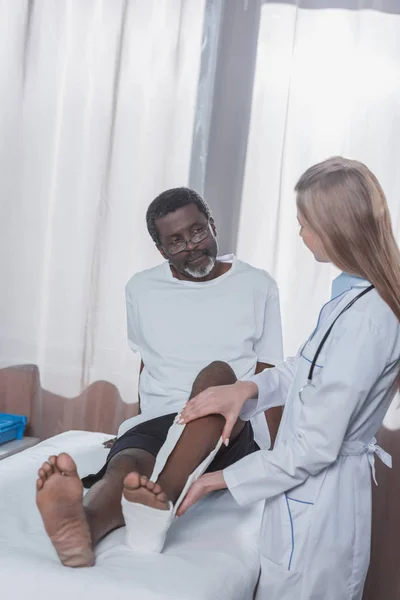 Doctor putting on plaster cast — Stock Photo