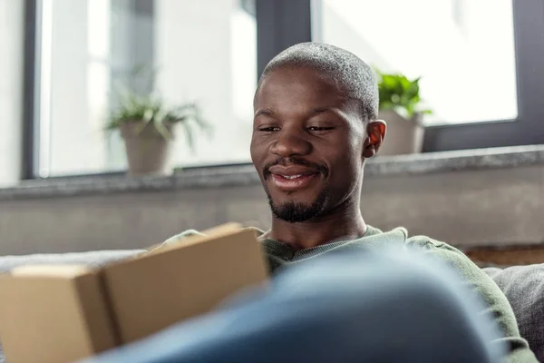 African american man reading book — Stock Photo