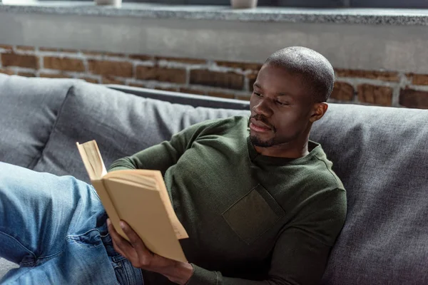African american man reading book — Stock Photo