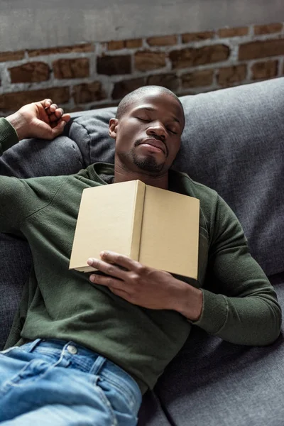 African american man sleeping on sofa — Stock Photo