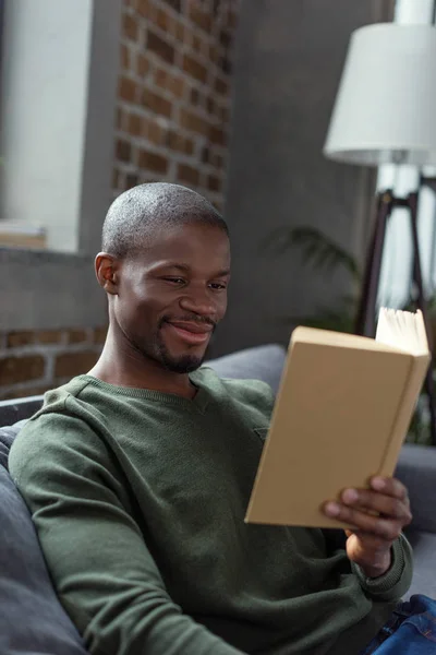 African american man reading book — Stock Photo