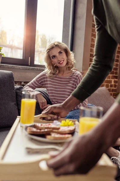 Cropped shot of african american boyfriend brought breakfast for caucasian girlfriend — Stock Photo