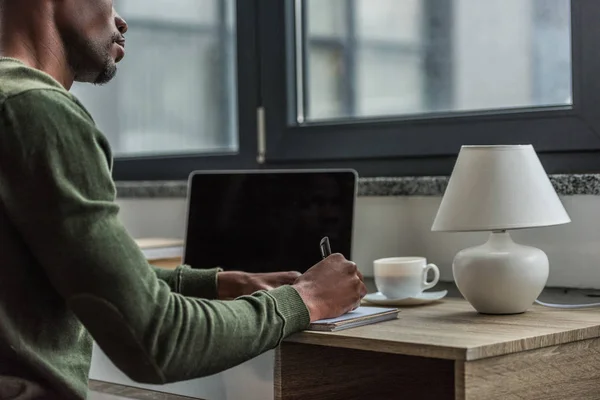 African american man making notes — Stock Photo