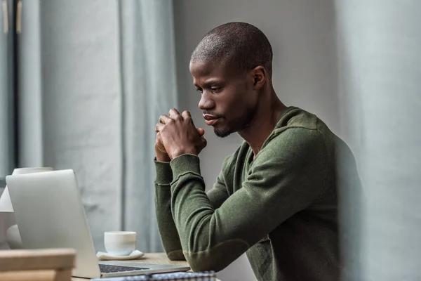 African american man with laptop at home — Stock Photo