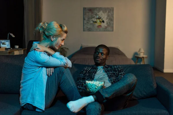 Young multicultural couple looking at each other at home — Stock Photo