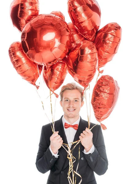Людина з повітряними кулями у формі серця — стокове фото