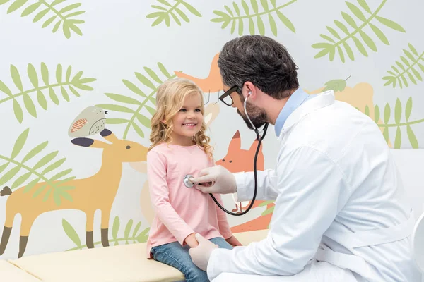 Pediatrist listening to breath of little girl — Stock Photo