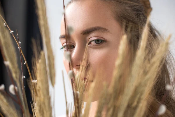 Headshot of beautiful woman with makeup and spikelets on foreground — Stock Photo