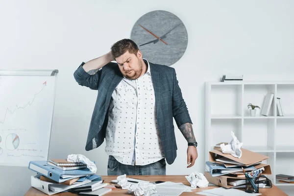 Overweight businessman in suit working with documents in office — Stock Photo