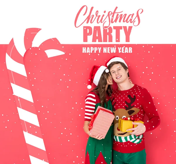 Couple in santa hats with gifts — Stock Photo