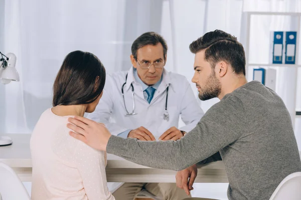 Boyfriend hugging and supporting girlfriend at clinic — Stock Photo