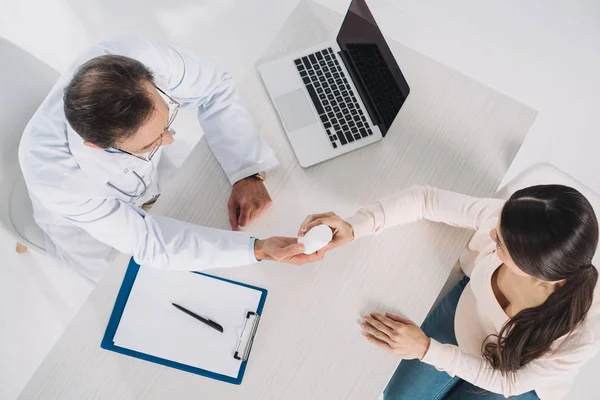 Vista aerea del medico che dà pillole al paziente femminile — Foto stock