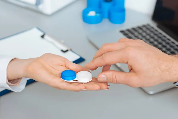 Cropped shot of doctor give contact lens to patient — Stock Photo