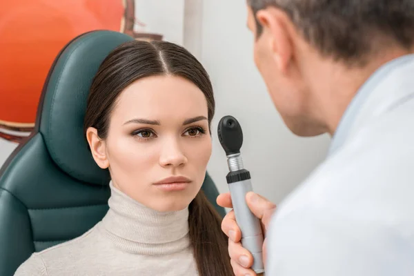 Selective focus of young woman getting eye test by oculist in clinic — Stock Photo