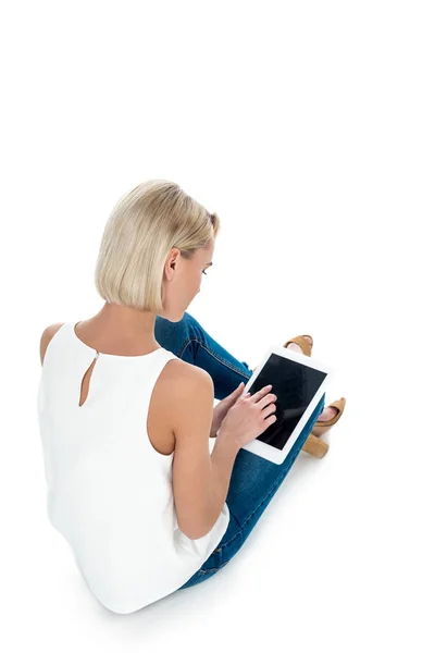 Back view of blonde woman using digital tablet with blank screen, isolated on white — Stock Photo