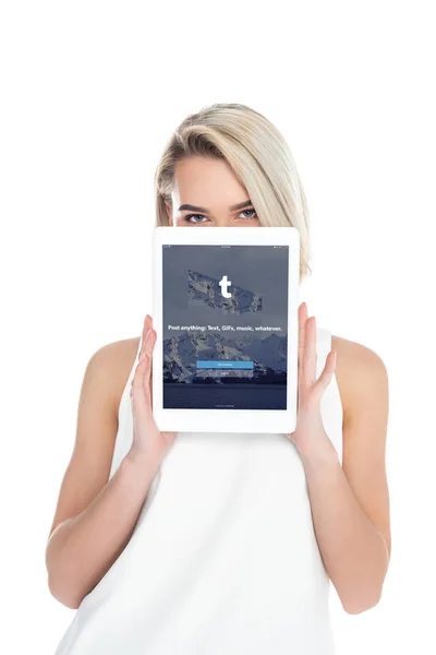 Mujer que presenta tableta digital con aplicación tumblr, aislada en blanco - foto de stock