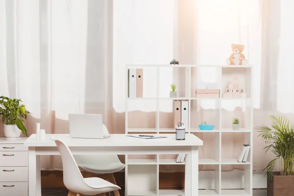 Doctors workplace and bookshelf with folders in clinic — Stock Photo