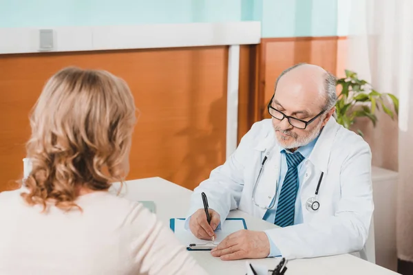 Partial view of woman at doctors reception in clinic — Stock Photo