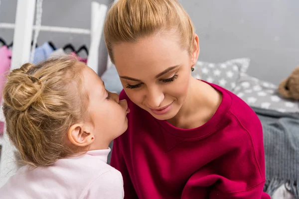 Adorable little daughter kissing her young mother — Stock Photo